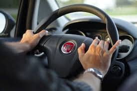 Common Extra Charges Associated with Car Rentals man driving